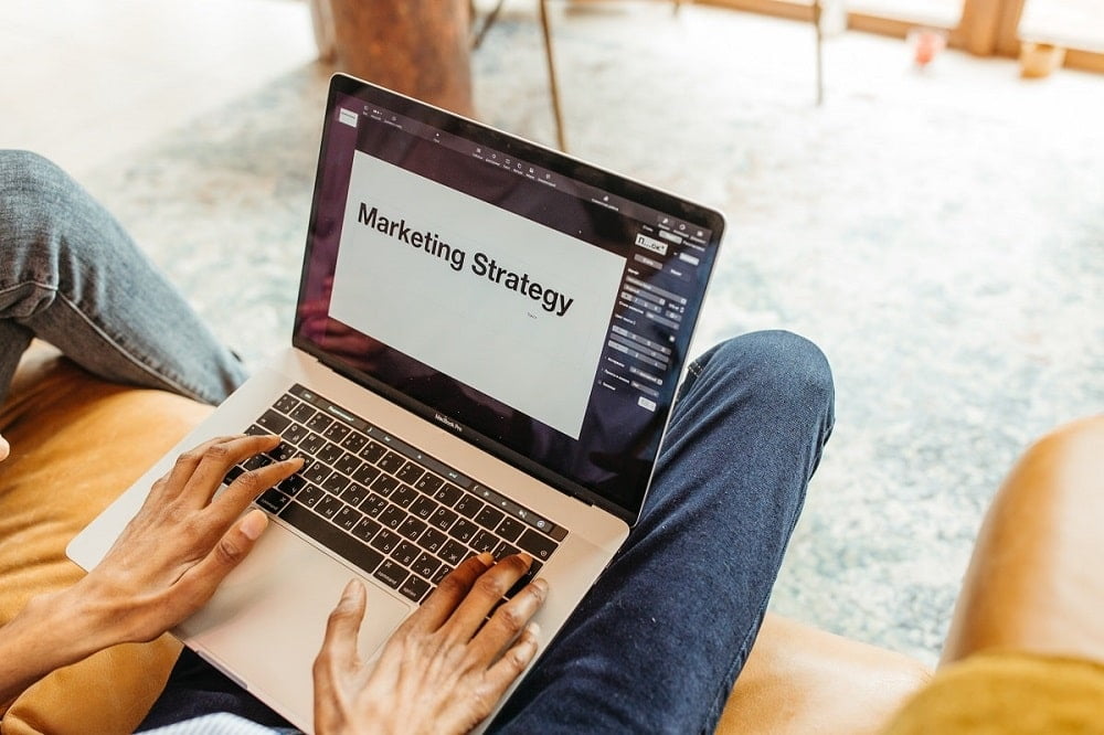 a man creating a social media marketing strategy on a laptop