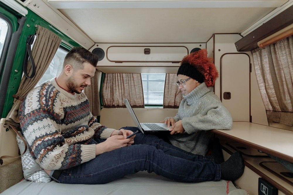 a couple working in a van with remote work
